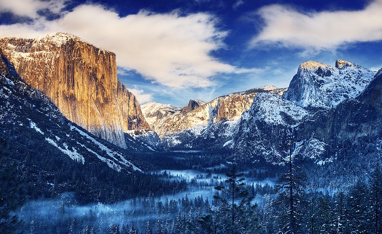 Sunrise over Yosemite Valley with snow capped mountains in early February.