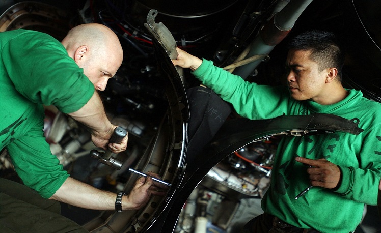 060617-N-5549O-045 Philippine Sea (June 17, 2006) - Aviation Structural Mechanic 2nd Class Chris Luebcke, left, and Aviation Structural Mechanic 3rd Class Rowel Dela Cruz replace turkey feathers from exhaust fairings on an F/A-18C Hornet assigned to the "Stingers" of Strike Fighter Squadron One One Three (VFA-113) aboard the Nimitz-class aircraft carrier USS Ronald Reagan (CVN 76). Ronald Reagan and embarked Carrier Air Wing One Four (CVW-14) are currently on a regularly scheduled deployment in support of the global war on terrorism and maritime security operations (MSO) and participating in Exercise Valiant Shield 2006. Valiant Shield focuses on integrated joint training among U.S. military forces, enabling real-world proficiency in sustaining joint forces and in detecting, locating, tracking and engaging units at sea, in the air, on land and cyberspace in response to a range of mission areas. U.S. Navy photo by Photographer's Mate 3rd Class Kevin S. O'Brien (RELEASED)